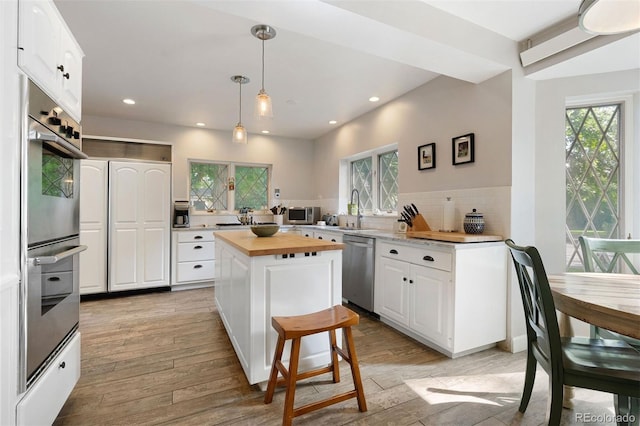 36 Lake Ave, Colorado Springs, CO 80906 - kitchen featuring stainless steel appliances, wooden counters, healthy amount of natural light, light wood-style floors, and recessed lighting