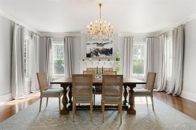 36 Lake Ave, Colorado Springs, CO 80906 - dining room with a chandelier, healthy amount of natural light, wood finished floors, and crown molding