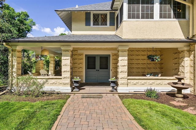 36 Lake Ave, Colorado Springs, CO 80906 - doorway to property featuring covered porch, stucco siding, and roof with shingles