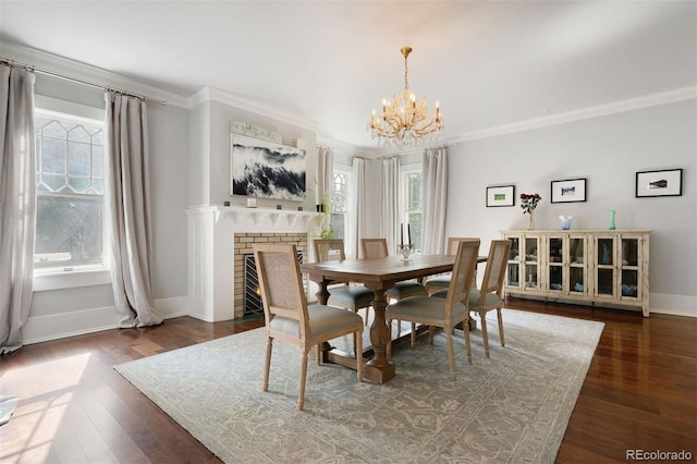 36 Lake Ave, Colorado Springs, CO 80906 - dining space with ornamental molding, a chandelier, baseboards, dark wood-style flooring, and a brick fireplace