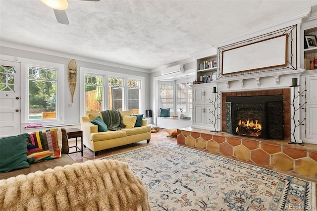 36 Lake Ave, Colorado Springs, CO 80906 - living room featuring a wall mounted AC, crown molding, a lit fireplace, ceiling fan, and a textured ceiling