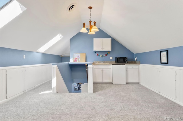 36 Lake Ave, Colorado Springs, CO 80906 - kitchen with a skylight, black microwave, fridge, wainscoting, and a sink