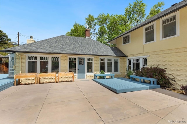 36 Lake Ave, Colorado Springs, CO 80906 - rear view of house with a patio, a chimney, and stone siding