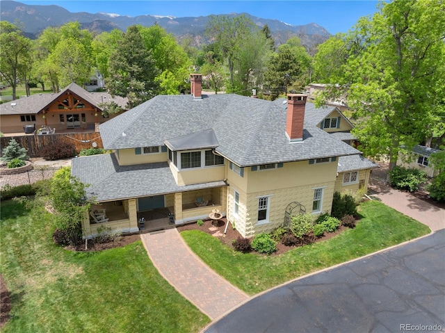 36 Lake Ave, Colorado Springs, CO 80906 - view of front of property featuring a chimney, a shingled roof, a porch, and a mountain view