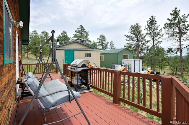 deck with a storage unit and grilling area