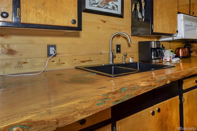 kitchen with wood walls and sink