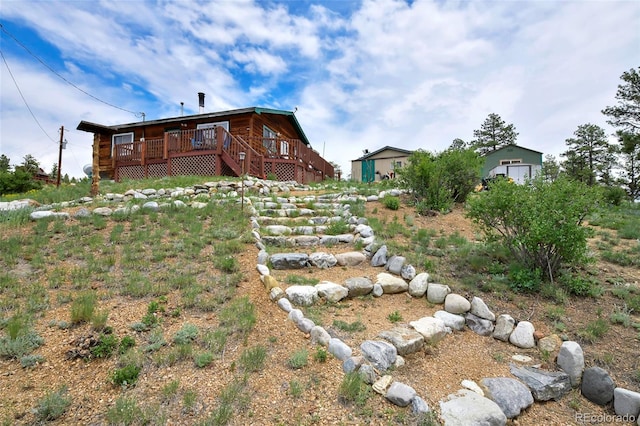 rear view of house featuring a wooden deck