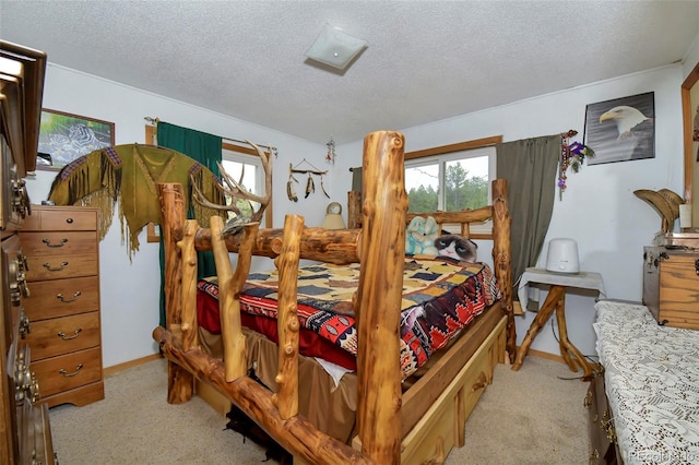 bedroom featuring a textured ceiling and light colored carpet