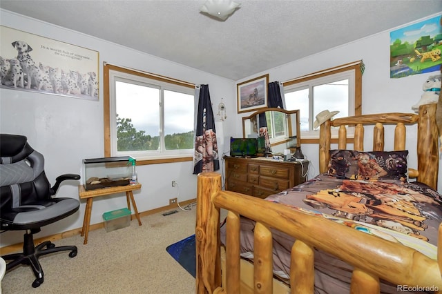 bedroom with a textured ceiling and light carpet