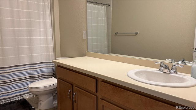 bathroom featuring vanity, toilet, and a shower with shower curtain