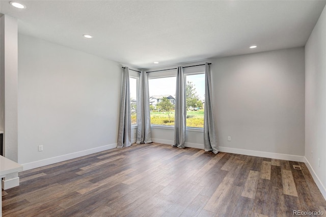 unfurnished room featuring dark hardwood / wood-style floors