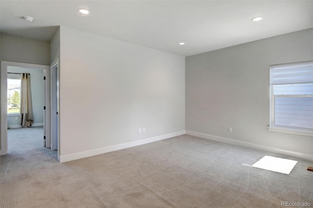 unfurnished room featuring light colored carpet