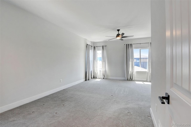 carpeted spare room featuring ceiling fan