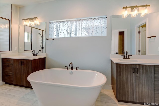 bathroom with vanity, plus walk in shower, and an inviting chandelier