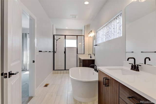 bathroom featuring vanity, tile patterned floors, and shower with separate bathtub