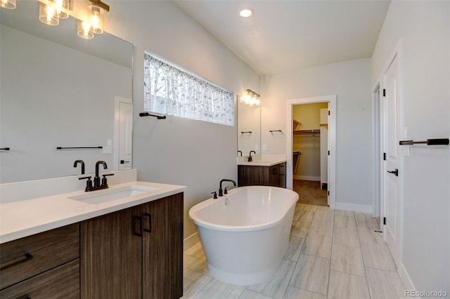 bathroom with vanity and a bath