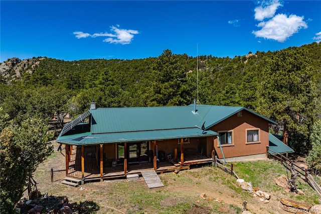 701/700 Bella Vista Ln, Cotopaxi, CO 81223 - rear view of property featuring a wooded view, metal roof, and a chimney