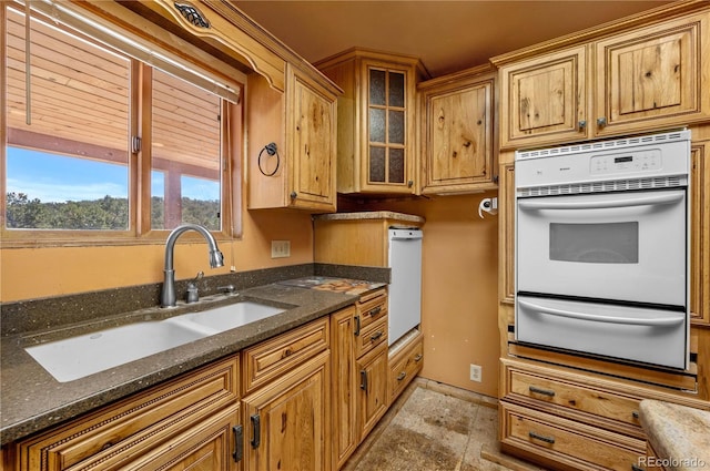 701/700 Bella Vista Ln, Cotopaxi, CO 81223 - kitchen with white oven, a warming drawer, a sink, dark stone countertops, and glass insert cabinets