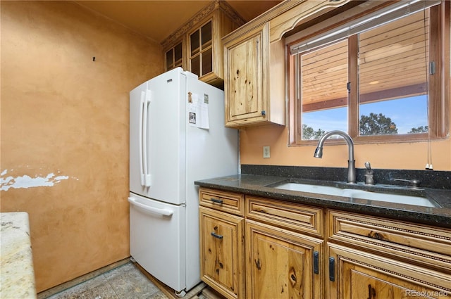 701/700 Bella Vista Ln, Cotopaxi, CO 81223 - kitchen featuring freestanding refrigerator, a sink, brown cabinets, and dark stone countertops