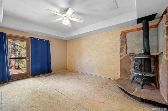 701/700 Bella Vista Ln, Cotopaxi, CO 81223 - unfurnished living room with a wood stove, a tray ceiling, and ceiling fan