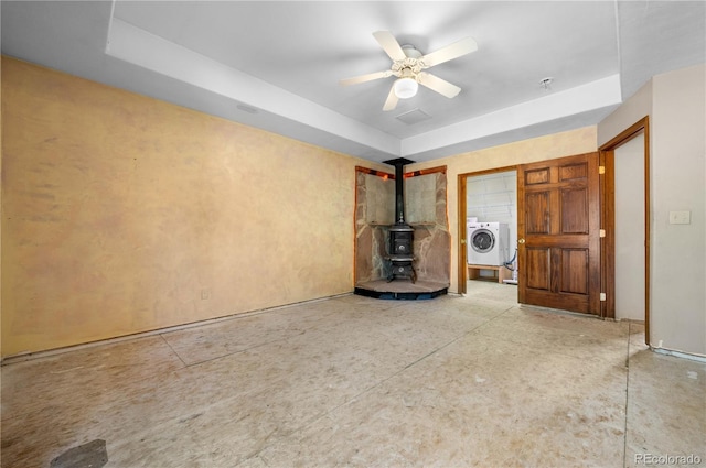 701/700 Bella Vista Ln, Cotopaxi, CO 81223 - unfurnished living room with a wood stove, washer / clothes dryer, a raised ceiling, and a ceiling fan