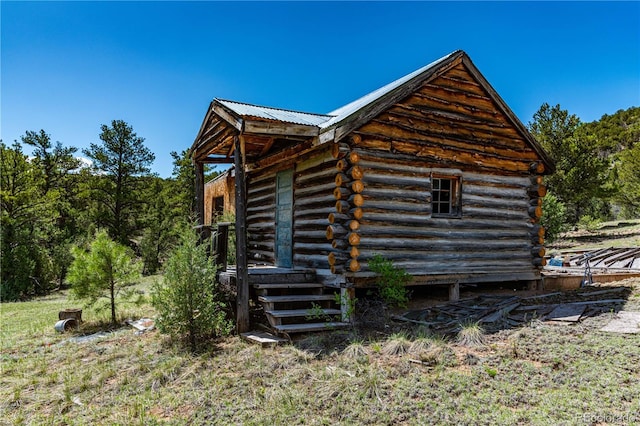 701/700 Bella Vista Ln, Cotopaxi, CO 81223 - view of home's exterior with log siding and metal roof