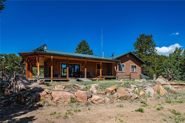 701/700 Bella Vista Ln, Cotopaxi, CO 81223 - rear view of house with metal roof and stucco siding