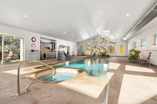 view of pool featuring an indoor hot tub and a water slide