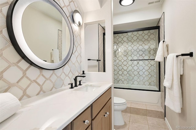 full bathroom with tile patterned floors, vanity, enclosed tub / shower combo, and toilet