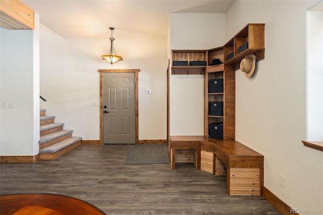 entryway with stairway, wood finished floors, and baseboards