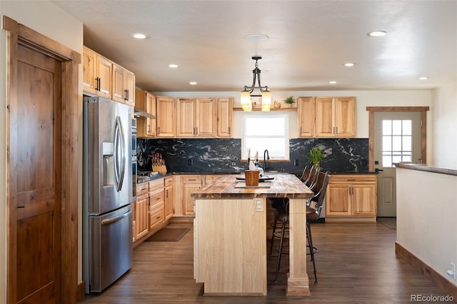 kitchen featuring dark wood finished floors, a kitchen island, stainless steel refrigerator with ice dispenser, and light brown cabinetry