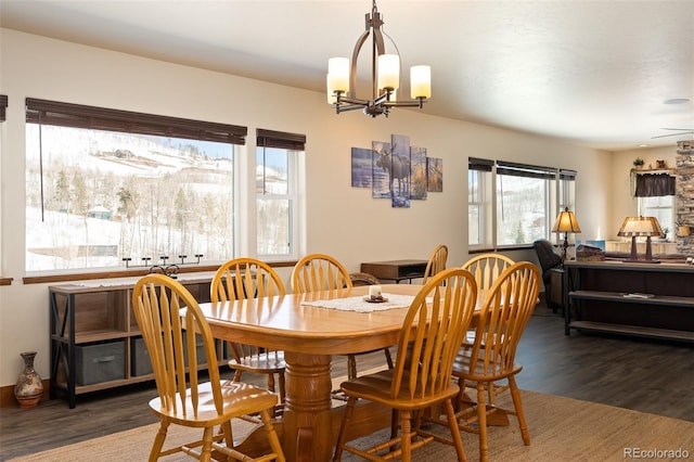 dining space with a chandelier and wood finished floors