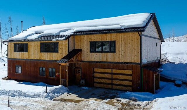 view of front of property featuring metal roof and an attached garage