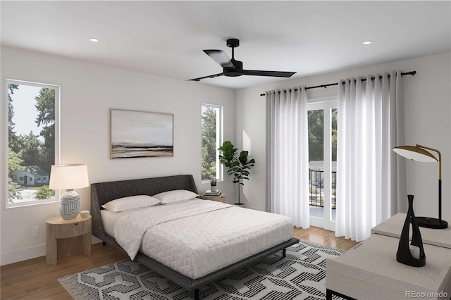 bedroom with recessed lighting, multiple windows, wood finished floors, and access to outside