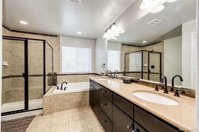 6528 S Kewaunee Way, Aurora, CO 80016 - bathroom featuring a garden tub, double vanity, a stall shower, and tile patterned floors