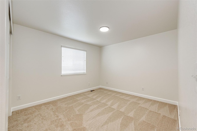 6528 S Kewaunee Way, Aurora, CO 80016 - spare room featuring light carpet and baseboards
