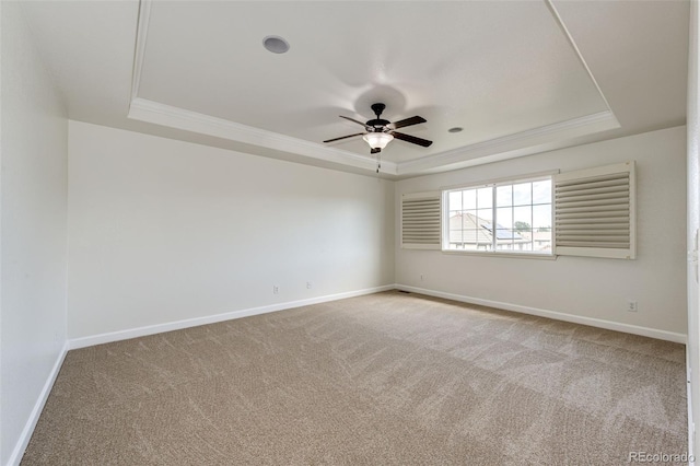 6528 S Kewaunee Way, Aurora, CO 80016 - empty room featuring a raised ceiling, light colored carpet, ceiling fan, and ornamental molding