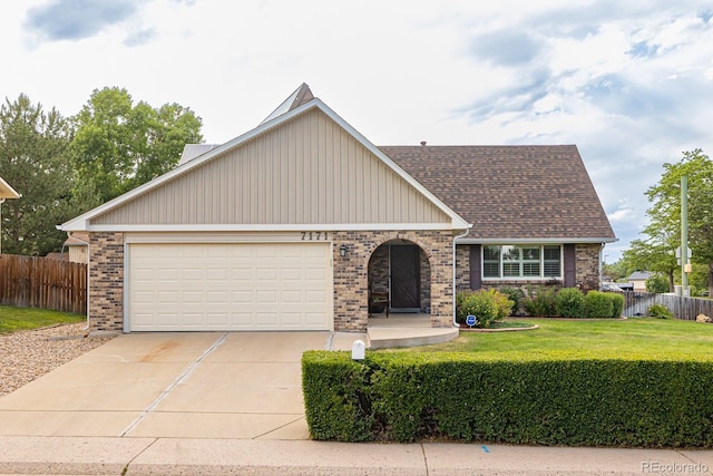 view of front of home with a front lawn and a garage