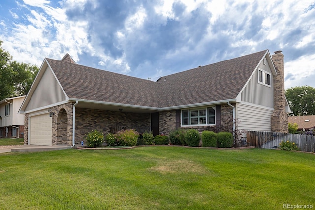 view of front of property featuring a front lawn and a garage