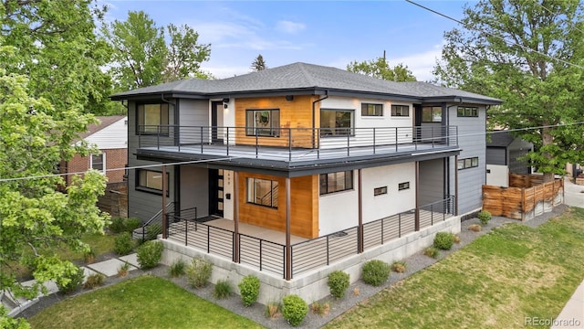 1490 S Vine St, Denver, CO 80210 - rear view of house with a balcony, a shingled roof, and a yard