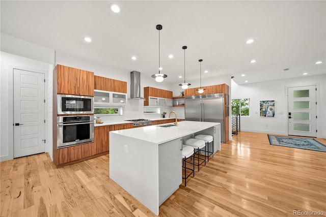 1490 S Vine St, Denver, CO 80210 - kitchen with built in appliances, brown cabinets, modern cabinets, wall chimney exhaust hood, and recessed lighting