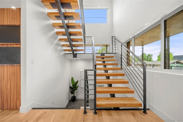 1490 S Vine St, Denver, CO 80210 - staircase with wood finished floors, baseboards, and a high ceiling