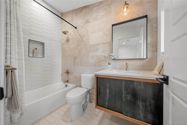 1490 S Vine St, Denver, CO 80210 - bathroom with tile walls, toilet, tile patterned floors,  shower combination, and vanity