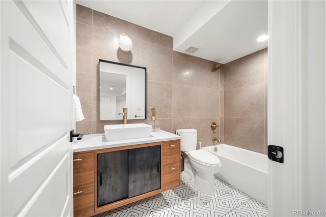 1490 S Vine St, Denver, CO 80210 - bathroom featuring tile walls, toilet, vanity, tile patterned flooring, and shower / bath combination