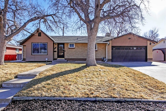 ranch-style home featuring a garage, brick siding, fence, driveway, and a front yard