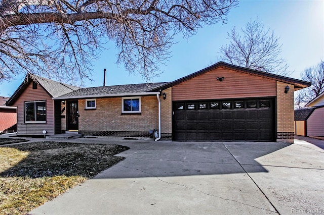 ranch-style home with a garage, concrete driveway, and brick siding