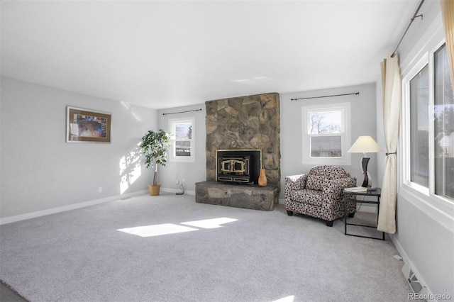 carpeted living room with visible vents, a wood stove, and baseboards