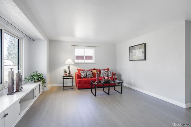 living area with wood finished floors and baseboards