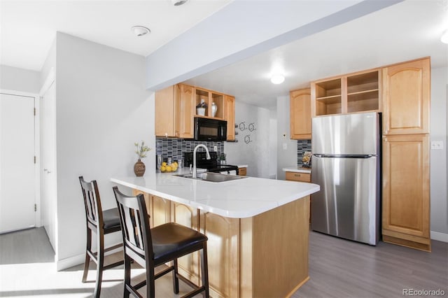 kitchen featuring open shelves, stainless steel appliances, a sink, and light brown cabinetry