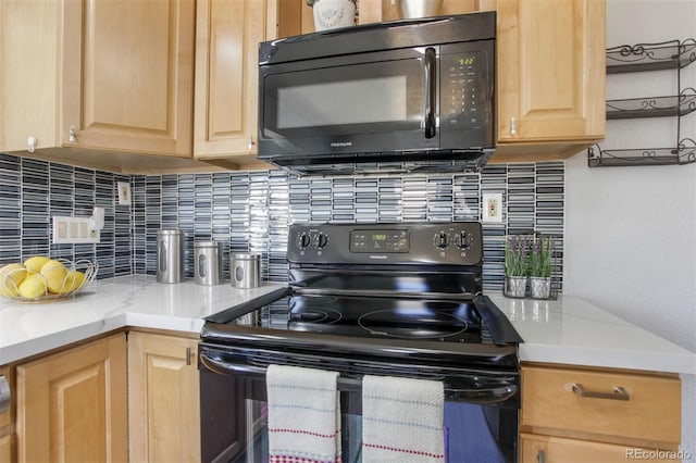 kitchen with black appliances, backsplash, light brown cabinets, and light countertops